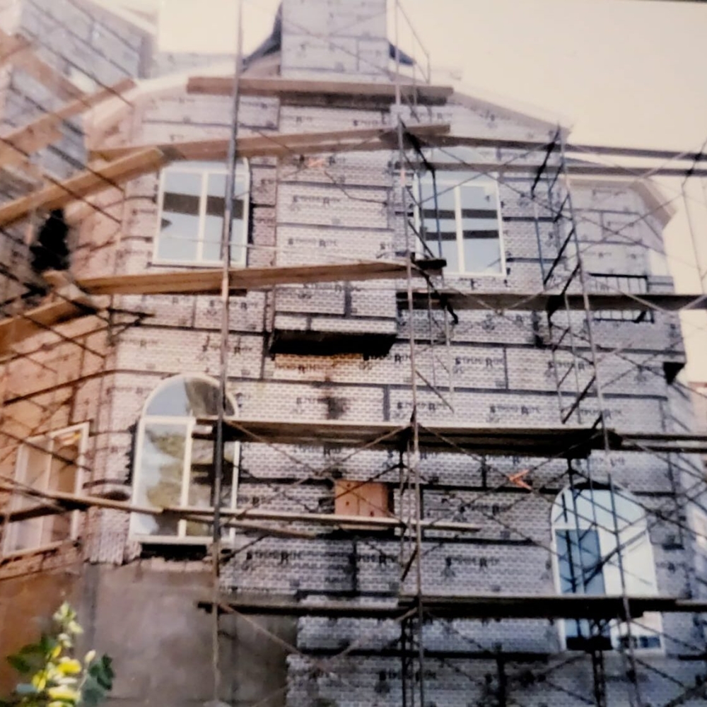 New York Project — brick building facade with scaffolding and safety netting