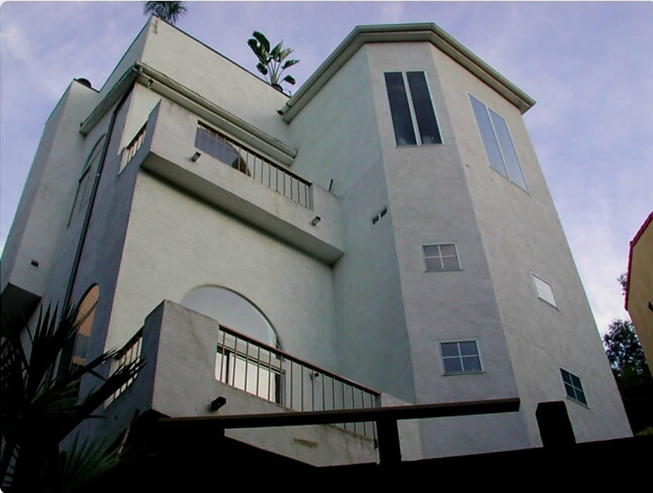 Building before — modern multi-story residential building with palm tree